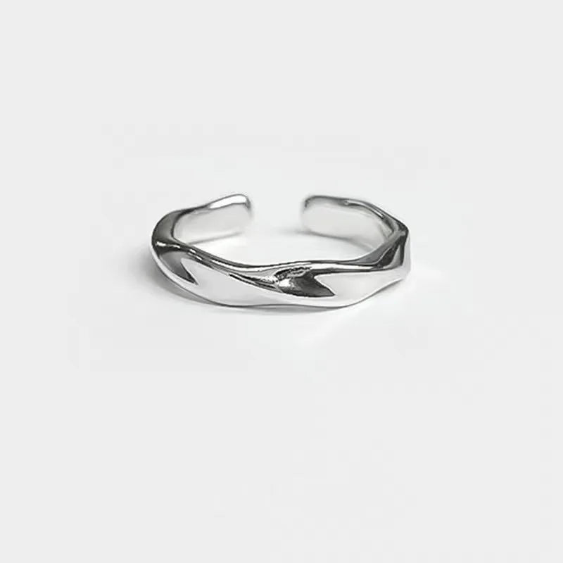 A small, niche, high-end Instagram-worthy ring in a minimalist, cool-toned, high-fashion style for both men and women.