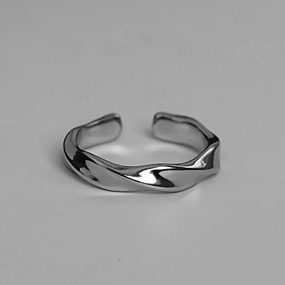 A small, niche, high-end Instagram-worthy ring in a minimalist, cool-toned, high-fashion style for both men and women.