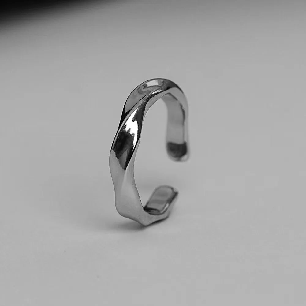 A small, niche, high-end Instagram-worthy ring in a minimalist, cool-toned, high-fashion style for both men and women.